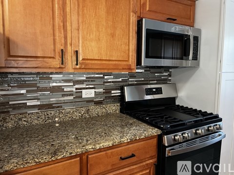 A kitchen with a stove and a microwave.
