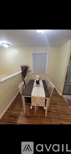A dining room with a table set for two.