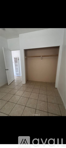 A room with a white door and a brown wall.