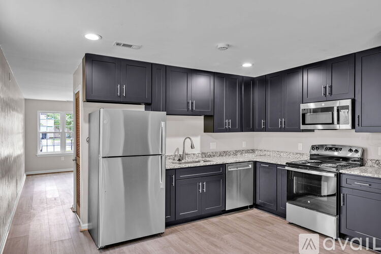 A kitchen with dark wood cabinets and stainless steel appliances.