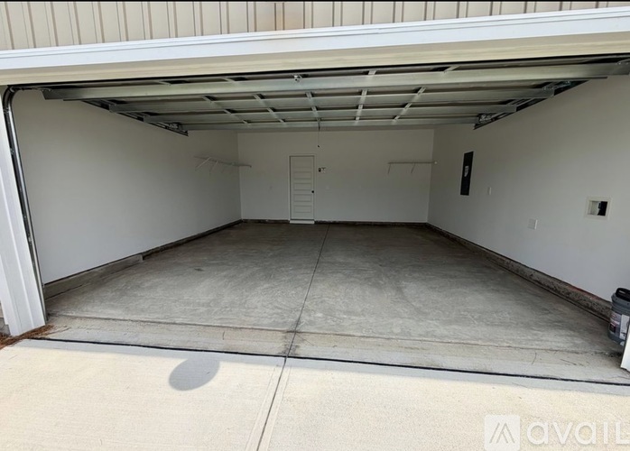 A spacious garage with a concrete floor and white walls.