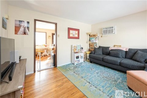 A living room with a grey couch and a television.