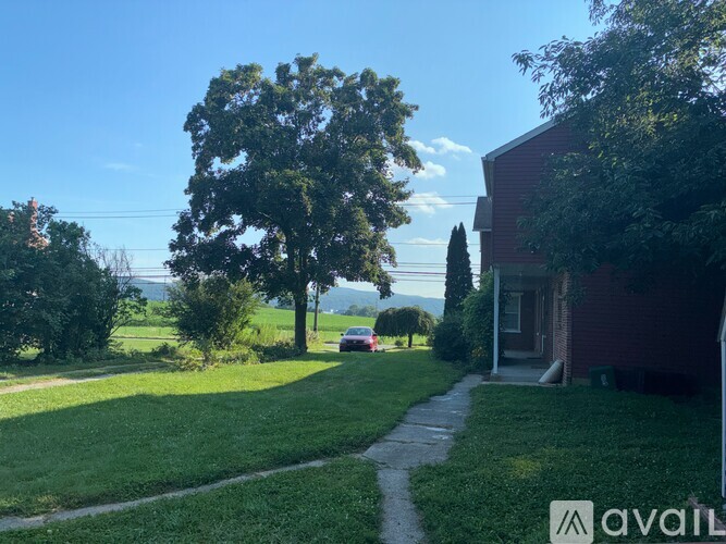 A house with a tree in front of it.