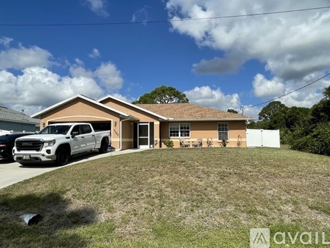 A house with a white pickup truck parked in front.