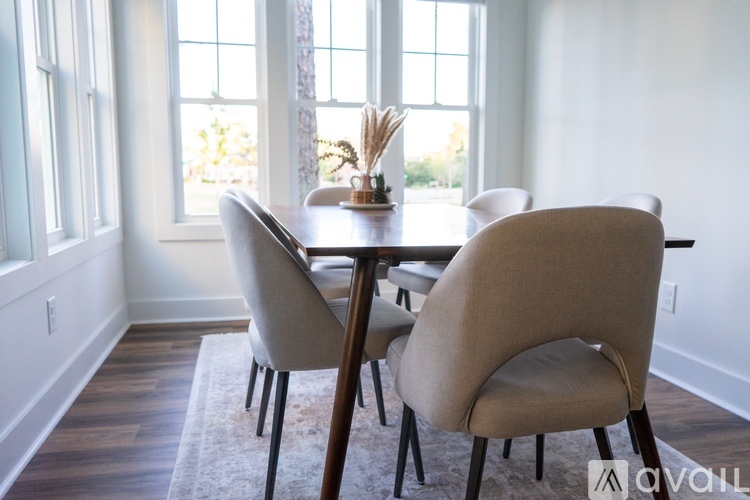 A dining room with a table and chairs.