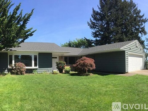 A house with a grey roof and a white garage door.