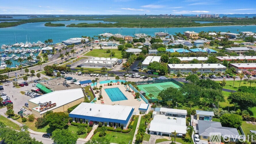 A bird's eye view of a resort with a swimming pool and a marina.