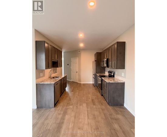 A modern kitchen with wooden cabinets and a marble countertop.