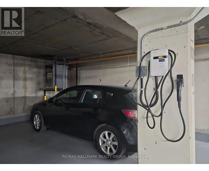 A black car is charging at a station.