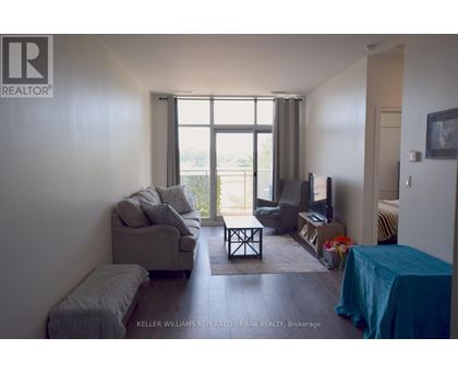 A living room with a grey couch and a blue tablecloth.