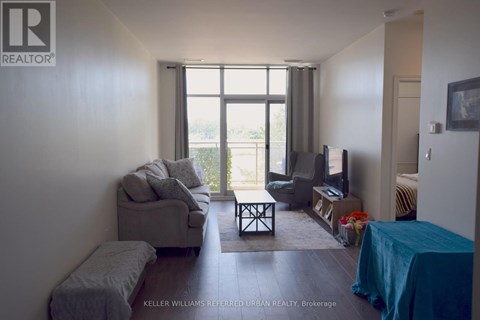 A living room with a grey couch and a blue tablecloth.