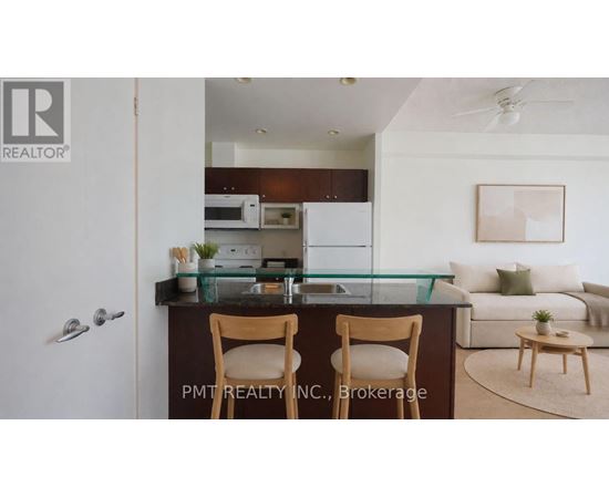 A kitchen with a bar stool and a couch.