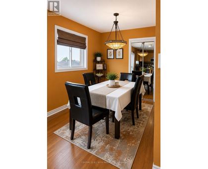 A dining room with a table set for six.