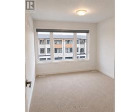 A room with a large window and a view of a building across the street.