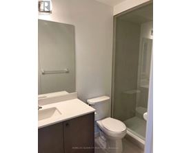 A white toilet sits next to a sink in a bathroom.