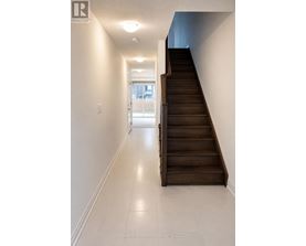A long hallway with a staircase on the right side.