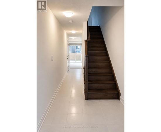 A long hallway with a staircase on the right side.