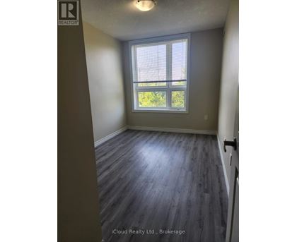 A room with a window and wooden flooring.