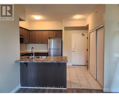 A kitchen with a granite countertop and stainless steel appliances.