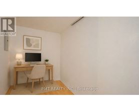 A room with a desk and chair in it.