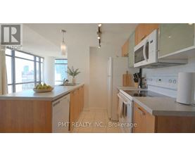 A kitchen with wooden cabinets and stainless steel appliances.