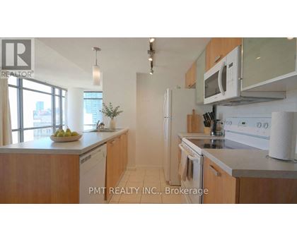 A kitchen with wooden cabinets and stainless steel appliances.