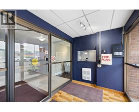 The image shows a glass door entrance to a building with a sign that reads "FIRE PLAN.".