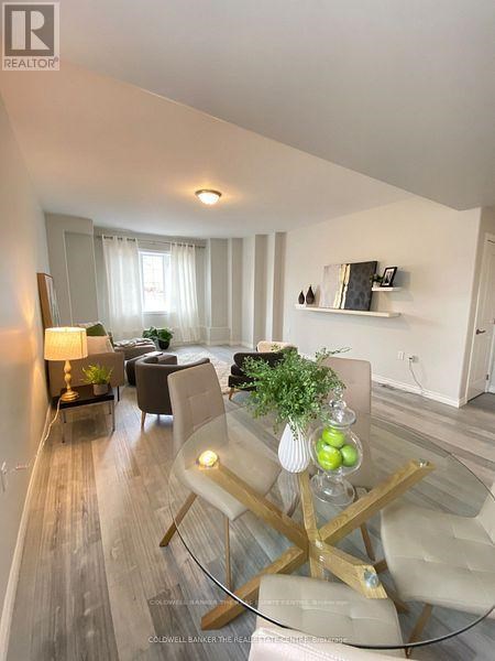 A modern living room with a glass table and white chairs.
