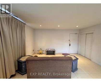 A room with a brown sofa and a star-shaped object on the table.