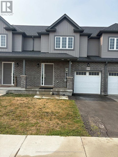 A grey house with a white garage door.