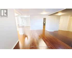 A room with wooden floors and white walls.