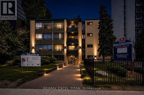 The image shows a building with a sign that reads "RE/MAX EXCEL TITAN Brokerage".