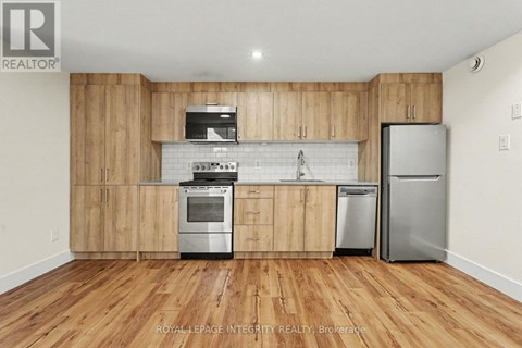 A kitchen with wooden cabinets and stainless steel appliances.