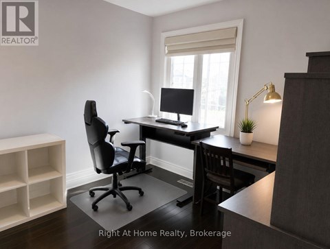 A room with a desk, chair, and a window.
