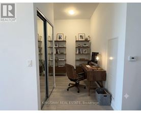 A room with a desk and a chair in it.