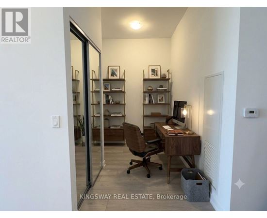 A room with a desk and a chair in it.