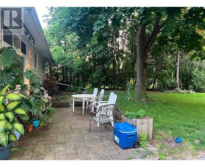 A backyard with a table and chairs.