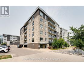 A large apartment building with a parking lot in front.