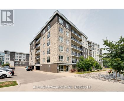 A large apartment building with a parking lot in front.