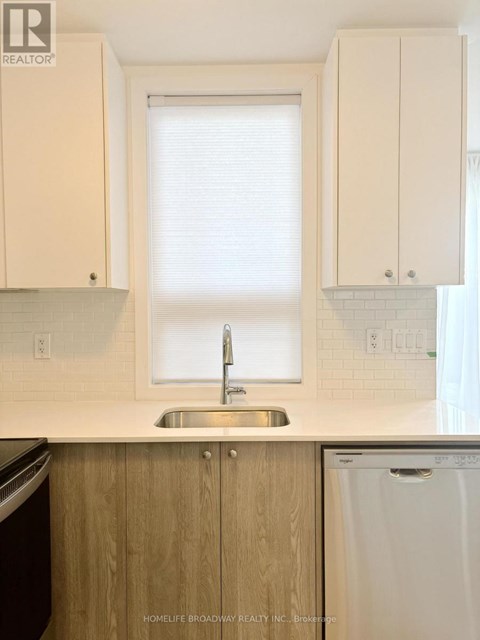 A kitchen with a sink and a window.
