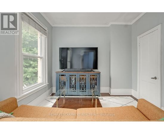 A living room with a television and a cabinet.