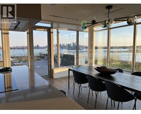 A modern dining room with a view of the city skyline.