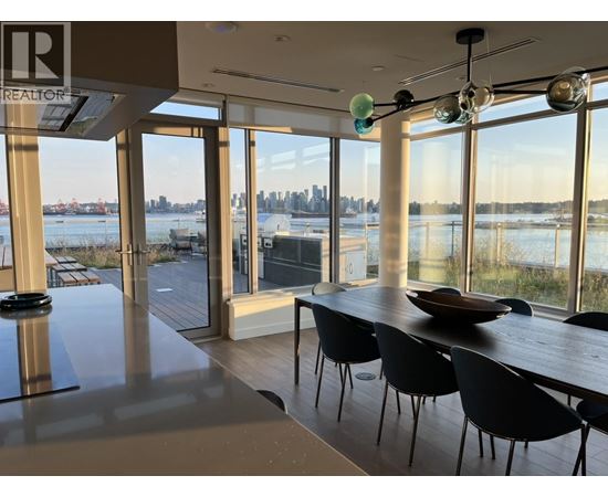 A modern dining room with a view of the city skyline.