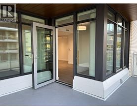 A modern house entrance with glass doors and a wooden ceiling.