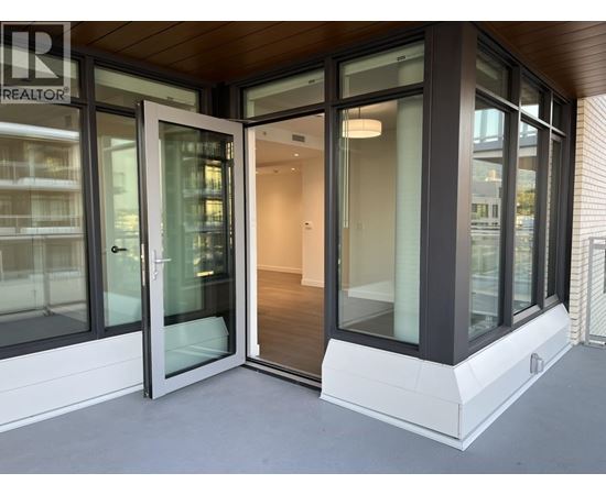 A modern house entrance with glass doors and a wooden ceiling.