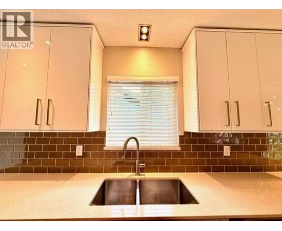A kitchen with a sink and cabinets.