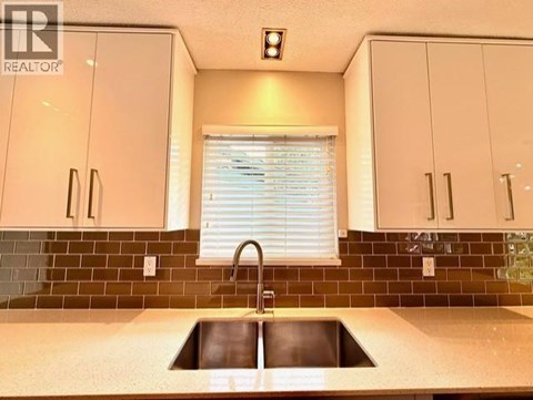 A kitchen with a sink and cabinets.