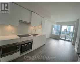 A modern kitchen with a large window and a view of the city.