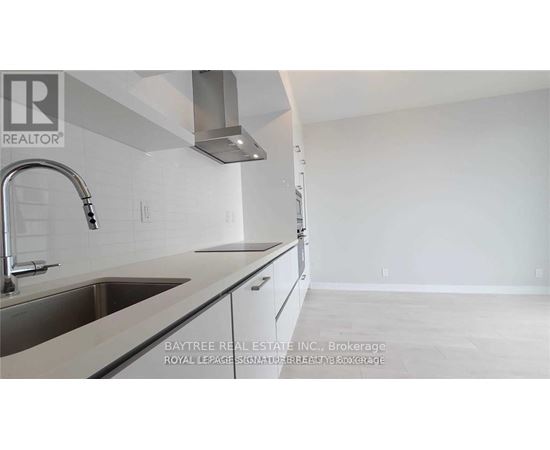 A kitchen with a sink and a stove top oven.