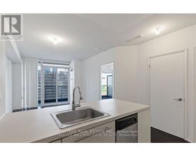 A kitchen with a sink and a window.